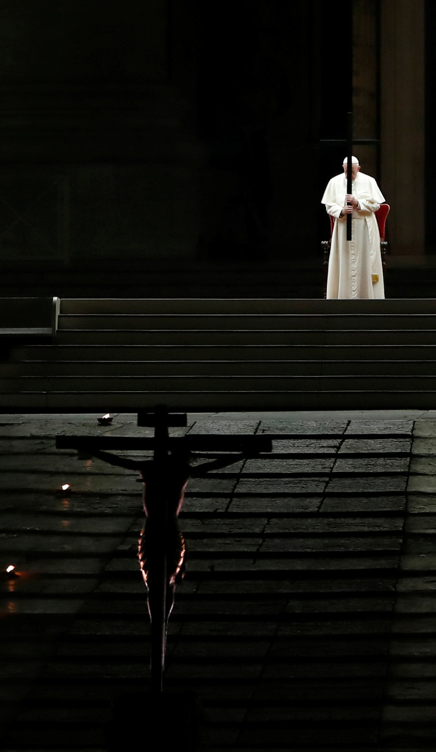 Pope Francis holds a cross as he leads the Via Crucis procession in St. Peter’s Square at the Vatican April 10, 2020. The Good Friday service was held with no public participation because of the COVID-19 pandemic.